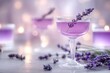 © Natalia Nechyporuk - Lavender cocktail garnished with fresh flowers on blurred sparkling background
