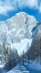 Wall Mural - Winter rock with fresh snow and alpine road.