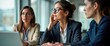 © Pete - Businesswomen in meeting actively listen during discussion in office. Thoughtful expressions show engagement. Pro women in business attire plan strategy. Serious atmosphere of collaboration,