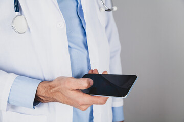 Wall Mural - close up of doctor hand holding smart phone with blank screen