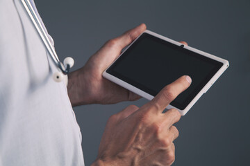 Wall Mural - close up of doctor holding digital tablet in hands