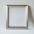 © Andrew - Silver Frame Mockup: A sleek silver picture frame casts a subtle shadow on a neutral backdrop, offering a sophisticated and versatile design element for showcasing your artwork, photos.