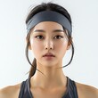 © Nurul - Athletic woman in headband with fresh and confident expression post-workout.