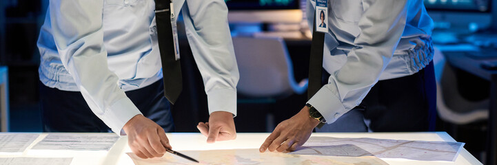 Leinwandbilder - Header of male and female military officers bending over table with paper documents while pointing at data during presentation