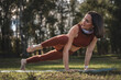 © Marko Domka - A woman is doing a yoga pose in a park
