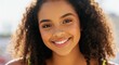 © gn8 - Radiant smiling young african female with curly hair in sunlit setting