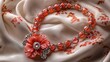 © Milaballe - Elegant coral beaded necklace with floral accent on satin fabric