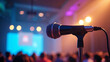© MOTOKO Stock - Sleek Microphone on Stand with Vibrant Bokeh: Perfect for Conference, Event, and Audio Equipment Marketing