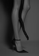 © sunaiart - A black snake is wrapped around the leg of a supermodel, showcasing slender legs and high heels.