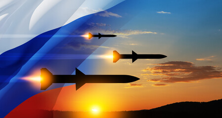 Wall Mural - Fired missiles fly to the target. Missiles at the sky at sunset with Russian flag.