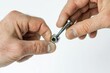 © Alla - A person holding a screw in their right hand