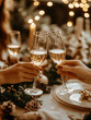 © AISTEL - Close-up of hands toasting with champagne flutes during a festive New Year celebration