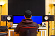 © princeoflove - back of asian professional music producer, composer, sound engineer, musician working in home recording studio