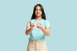 © Pixel-Shot - Diabetic young woman using lancet pen on blue background