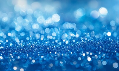 Abstract, elegant, detailed blue glitter particles flow with shallow depth of field underwater. Sparkle and light background. Holiday magic.