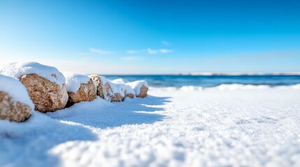 Wall Mural - rocky shoreline with snow on the rocks and the beach.