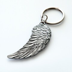 Wall Mural - Wing-shaped keychain on a white isolated background.