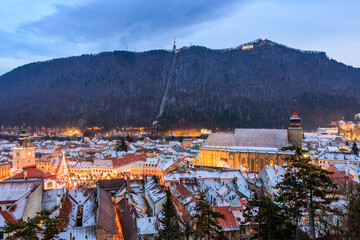 A city at night with a large mountain in the background