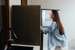 © SHOTPRIME STUDIO - Young woman looking into an empty refrigerator, depicting a moment of uncertainty and a need for healthy food choices in a minimalist kitchen setting