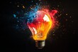 © anak - Illuminated lightbulb exploding with vibrant red, blue, and orange powder against a black background.