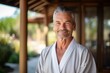 © Inigo - Portrait of a senior man in bathrobe smiling at the camera