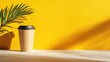 © Cherrin - Minimal mug concept. Bright yellow background featuring a coffee cup and a palm leaf, creating a vibrant, casual aesthetic.