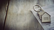 © Kosin - key with house shaped keychain rests on home loan document, symbolizing new beginnings and home ownership. This captures essence of securing new home