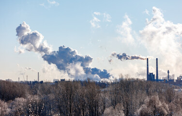 Wall Mural - A large cloud of smoke is rising from a factory