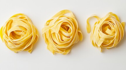 Fettuccine pasta nests displayed in isolation on a clean white background, showcasing the unique texture and shape of fettuccine pasta for culinary inspirations and presentations.