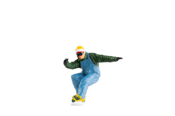 Wall Mural - Miniature figurine depicting a snowboarder in mid-motion isolate on white background with clipping path