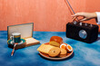 © VISTA by Westend61 - Woman turning retro radio kept on table near breakfast