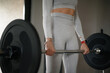 © WellStock - Person Lifting Barbell in Gray Athletic Wear