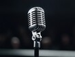 © Sergey - A retro-style microphone stands prominently against a blurred background, symbolizing performance or public speaking.