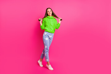 Wall Mural - Full size photo of attractive girl touching her haircut looking with beaming smile posing wearing knitted jumper dotted denim jeans isolated over fuchsia background