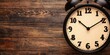 © CassiOpeiaZz - A vintage alarm clock displays time against a rustic wooden background, emphasizing a classic and timeless aesthetic.