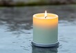 © good everyday - Lit candle on water, gentle ripples.
