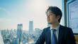 © bephoto - 朝の光に包まれたオフィスで市場を分析する日本人男性ファイナンシャルアナリスト