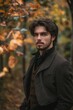 © StockUp - A young man poses thoughtfully among autumn foliage, conveying a sense of meditation and reflection.