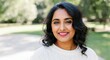 © gn8 - Confident south asian woman smiling outdoors in natural park setting