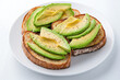 © Adisak - Creamy avocado slices on warm toasted bread, delicious snack for affordable food concept