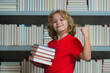 © Volodymyr - Successful school boy. Little student on school library. Child reading book at school. Nerd pupil studying at school. Clever intelligent schoolboy overwork. Smart child learning to read book.