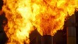 © Dream maker - Flames erupting from industrial smokestacks during nighttime at a power generation facility