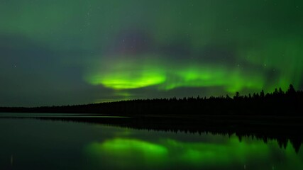 Wall Mural - time lapse of night sky filled with green and yellow aurora reflecting in a calm lake