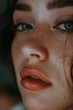 © Luisa - A young woman with an even complexion and glittered skin, highlighting her lips with a vibrant red lipstick.