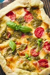 Wall Mural - Galette-type pie made from puff pastry and filled with tomatoes, mozzarella cheese and pesto sauce. Galette Caprese