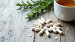 © Tameem - Magnesium supplements displayed on a wooden surface with a cup of tea and dried rosemary sprigs.