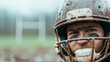 © Bonsales - Muddy rugby player wearing protective gear, helmet and mouthguard, with distant goalposts marking competitive field landscape