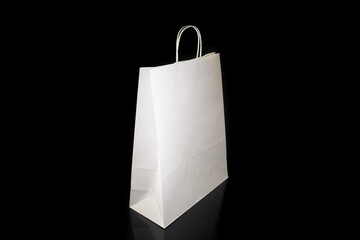 Recyclable craft paper bag for purchases, gifts and takeaway food mock up on black background. Environmentally friendly than single-use plastic bags