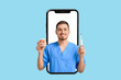 © Pixel-Shot - Male dentist with plastic jaw model and electric toothbrush on light turquoise background