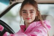 © LimeSky - Attractive young woman in a pink jacket near a steering wheel feeling upbeat during a driving test